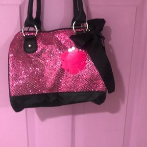 Candie’s pink sequin purse with black bow
